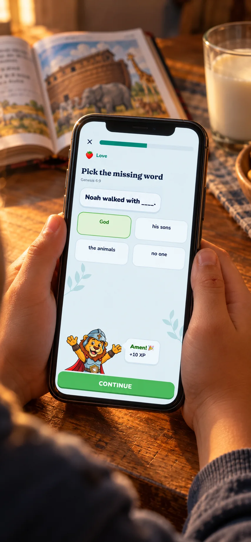 A child's hands holding the app at the kitchen table